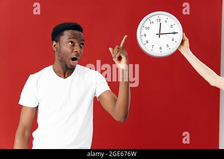 man of african appearance looking at watch studio lifestyle Stock Photo