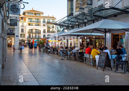 Arcachon (south western France): buildings, shopping street and tourists seated on the terrace of a restaurant in the heart of the town, street “rue E Stock Photo