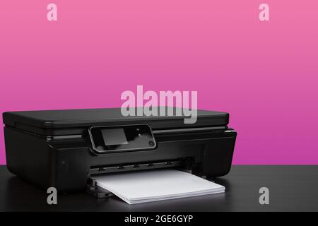 Compact home laser printer against pink background Stock Photo