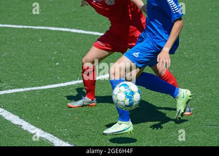 Girls football players equipped with Nike and Select sport equipment struggling for the ball on the soccer field. August 10, 2021. Kyiv, Ukraine Stock Photo