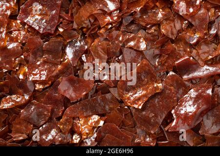 Brown Shellac dry flakes close up full frame as background Stock Photo