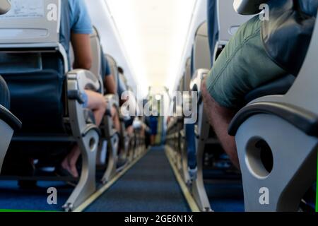 Airplane background selective focus. Blur. The passage between the seats inside the aircraft cabin. Passengers are ready to fly. Stock Photo