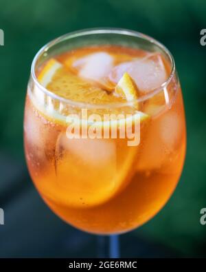 Aperol Spritz Aperitivo summer cocktail drink in original glass with oranges and mint twig on wooden table background. Food and drink photography Stock Photo