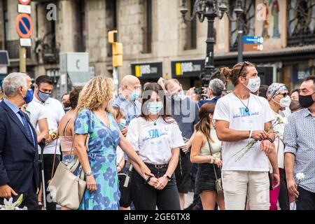 Barcelona, Catalonia, Spain. 17th Aug, 2021. Families of the victims of the jihadist attack on La Rambla are seen at the anniversary ceremony of the attack.Barcelona pays tribute to the victims on the fourth anniversary of the jihadist attack on La Rambla where on August 17, 2017, a van carried out the massive outrage, which caused the death of 15 people.The families of the victims have been the protagonists of the ceremony, depositing white carnations and bouquets of flowers in three cylinders. This was followed by the authorities, with the mayor of Barcelona, Ada Colau, the president of t Stock Photo