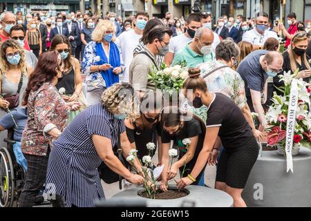 Barcelona, Catalonia, Spain. 17th Aug, 2021. Families of the victims of the jihadist attack on La Rambla are seen laying flowers at the anniversary ceremony of the attack.Barcelona pays tribute to the victims on the fourth anniversary of the jihadist attack on La Rambla where on August 17, 2017, a van carried out the massive outrage, which caused the death of 15 people.The families of the victims have been the protagonists of the ceremony, depositing white carnations and bouquets of flowers in three cylinders. This was followed by the authorities, with the mayor of Barcelona, Ada Colau, the Stock Photo