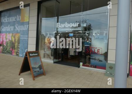 Barbour shop in Rushden Lakes Northamptonshire UK poster shop front clothing clothes store front frontage glass new place sale outside manufacture Stock Photo