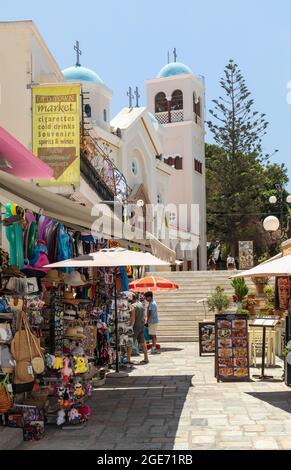 Restaurant and Tourist shop in the Old Town Market of Kos Town with Agia Paraskevi Church in the background, Kos, Dodecanese Islands, Greece Stock Photo