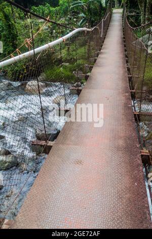 Suspension bridge over Caldera river near Boquete Panama , on Lost Waterfalls hiking trail. Stock Photo