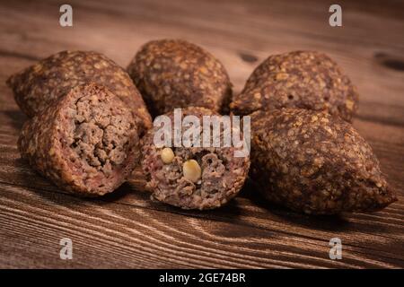 Traditional kebbe and pita bread on big round plate in lebanese restaurant Stock Photo