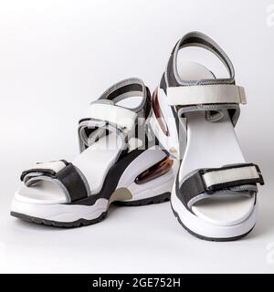 Women's, fashionable, sports sandals on a white background. New youth shoes for girls. Foreground. Stock Photo