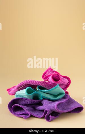 Multicolored microfiber cloths for washing on a neutral beige background, cleaning concept Stock Photo