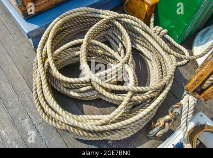 Traditional ropework on an old sailing ship designed to keep the deck safe and orderly. Closeup. Stock Photo
