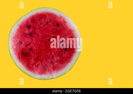 half of fresh watermelon isolated on yellow background, cross section with copy space Stock Photo