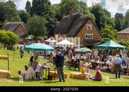UK, England, Oxfordshire, Wroxton, annual church fete in progress, stalls at edge of village green Stock Photo