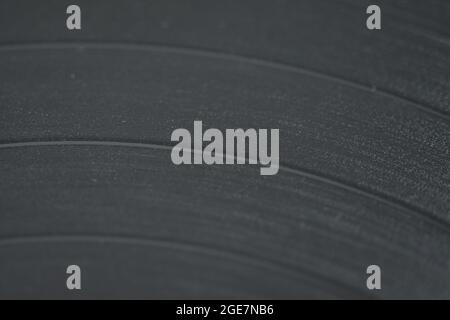 Vinyl enlarged, dust and fern in the grooves with music. Stock Photo