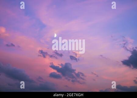 Majestic dusk. Twilight in the evening with gentle sunlight. Abstract nature background. Pink, purple, lilac colors of sky with dark clouds and young Stock Photo