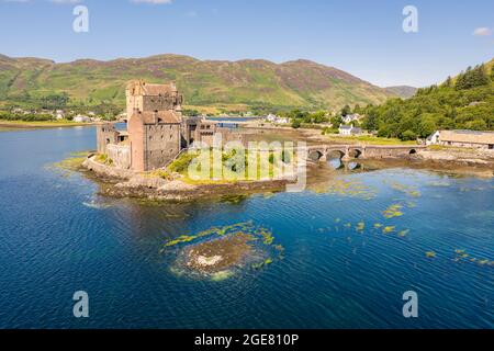 Aerial Drone Eilean Donan sunset castle Scotland UK Dornie Loch Duich Island bridge Highlands Landmark Landscape Highlander travel Stock Photo