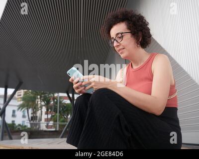 Caucasian young woman in the city using mobile phone Stock Photo
