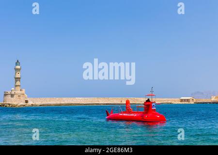 CHANIA, CRETE - 22 JULY 2021: A semi-submarine tourist boat entering the old Venetian port of Chania, Crete Stock Photo