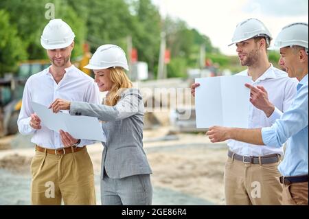 Determined female inspector performing the on-site construction supervision Stock Photo