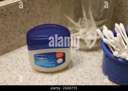 Vaseline, dental floss toothpick, and ear swabs Stock Photo