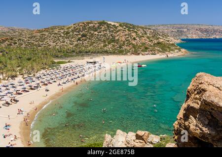 VAI, CRETE - 15 JULY 2021: Crowds of tourists on the picturesque palm fringed beach of Vai on the eastern coast of Crete (Greece) Stock Photo