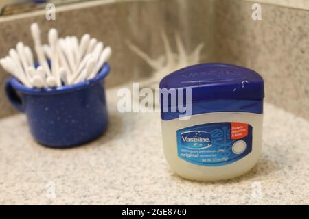 Vaseline, dental floss toothpick, and ear swabs Stock Photo