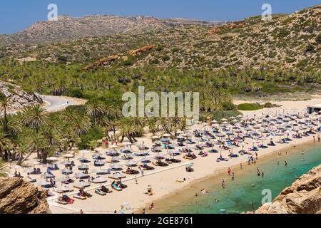 VAI, CRETE - 15 JULY 2021: Crowds of tourists on the picturesque palm fringed beach of Vai on the eastern coast of Crete (Greece) Stock Photo