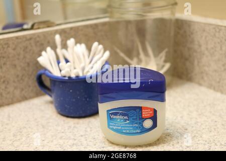 Vaseline, dental floss toothpick, and ear swabs Stock Photo