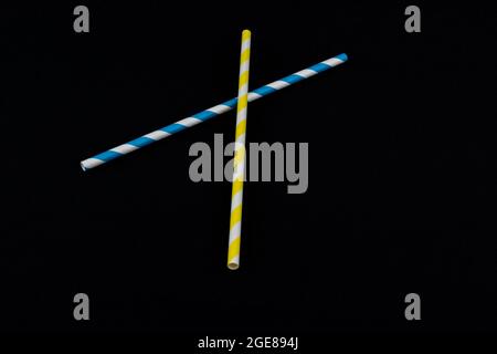 Multicolored paper straws isolated on a black background Stock Photo