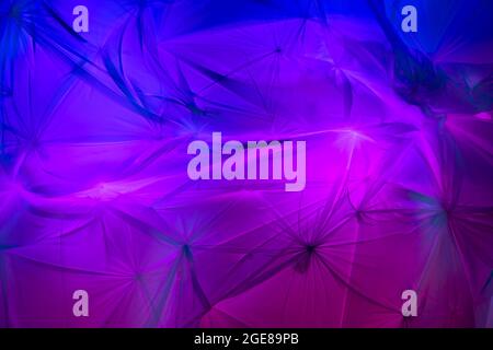 Backdrop of Flowing colorful fabric with light and shadows Stock Photo