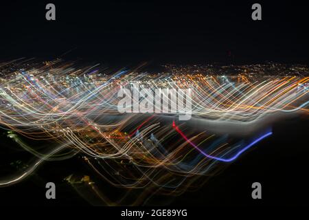 Abstract effect Wellington city urban bright night lights across city with wave and color pattern shot using long exposure and intentional camera move Stock Photo