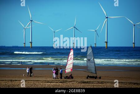 Beach buggy sailing with Teesside Wind Farm, or alternatively referred to as Redcar Wind Farm on Coatham beach, north east coast of England, UK Stock Photo