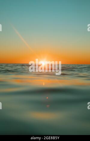 Sun rising over the water at Mollymook Beach. Stock Photo