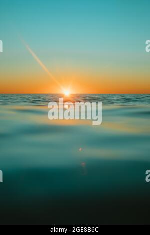 Sun rising over the water at Mollymook Beach. Stock Photo