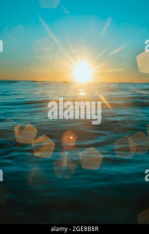Sun rising over the water at Mollymook Beach. Stock Photo