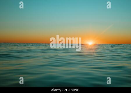Sun rising over the water at Mollymook Beach. Stock Photo