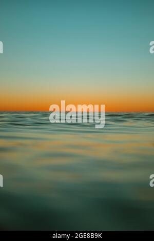 Sun rising over the water at Mollymook Beach. Stock Photo