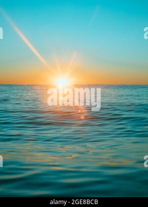 Sun rising over the water at Mollymook Beach. Stock Photo