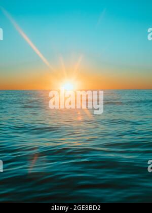 Sun rising over the water at Mollymook Beach. Stock Photo