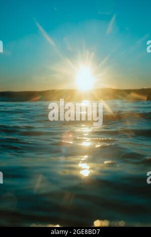 Sun rising over the water at Mollymook Beach. Stock Photo