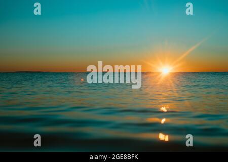 Sun rising over the water at Mollymook Beach. Stock Photo