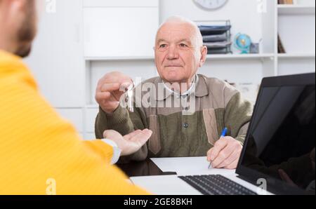 Man selling house in office Stock Photo