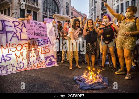 Barcelona, Spain. 17th Aug, 2021. Demonstrators are seen burning a burqa during the demonstration. Around a hundred women have participated in a feminist demonstration in front of the United Nations headquarters in Barcelona to demand an urgent international response to protect Afghan women and girls. Credit: SOPA Images Limited/Alamy Live News Stock Photo