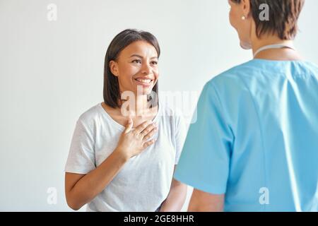 Happy grateful afro american young woman patient thanking doctor for professional consultation Stock Photo