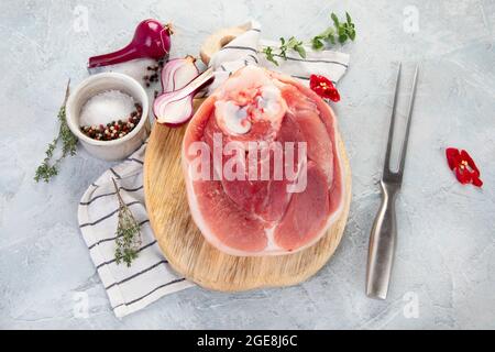 Raw ham leg on ligth gray background. Organic gourmet food concept. Top view, flat lay Stock Photo