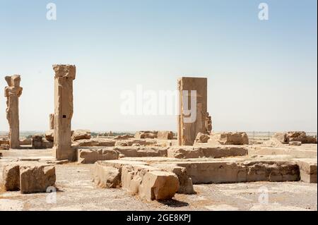 Fabulous view of ruins of the Hadish Palace (the Palace of Xerxes) on blue sky background in Persepolis, Iran. Ancient Persian city. Persepolis is a p Stock Photo