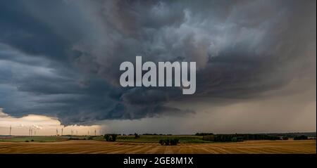ThunderStorm over fields, a huge storm cloud that causes heavy rainfall Stock Photo