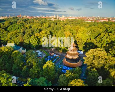 MUNICH, GERMANY - Aug 17, 2021: Aerial view of chinese tower in english garden munich. Historic building is a popular beer garden in central park of b Stock Photo