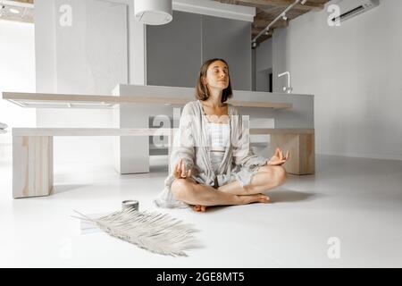 Woman meditating at home Stock Photo